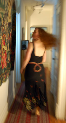 The dress worn, seen from behind, blurred with motion